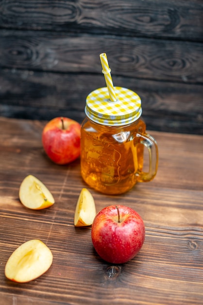 Front view fresh apple juice with fresh apples on brown wooden desk photo cocktail fruits drink color