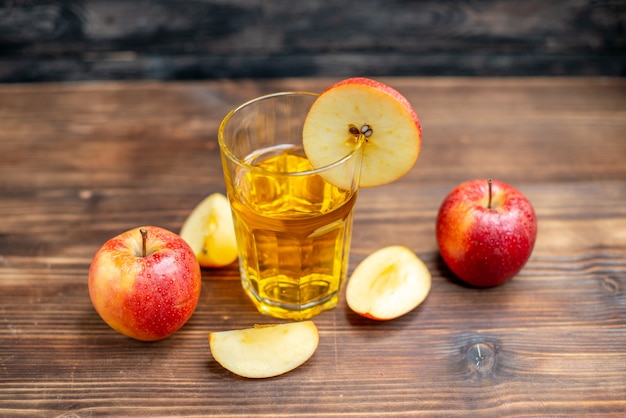 Front view fresh apple juice with fresh apples on brown wooden desk photo color cocktail fruit drink