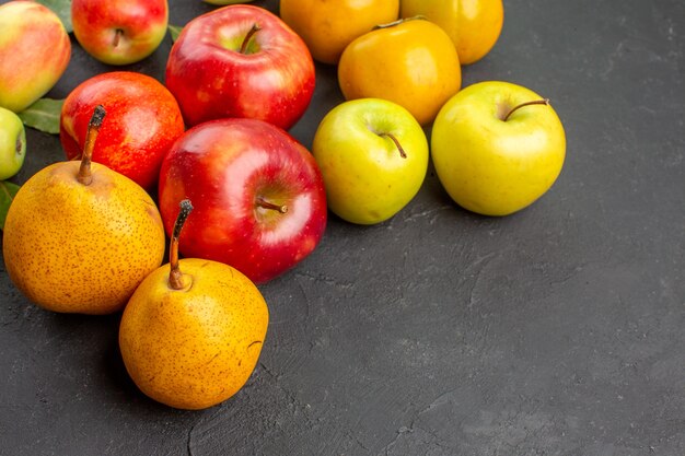 Front view fresh apples with pears and persimmons on dark table fresh ripe mellow tree