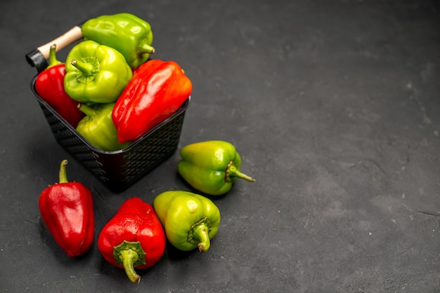 Free photo front view fresh bell-peppers inside basket on dark floor meal salad color photo ripe