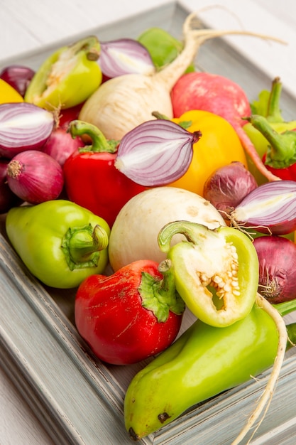 Front view fresh bell-peppers with radish and onions on the white vegetable pepper color ripe salad healthy life meal photo