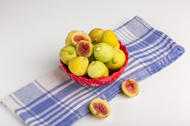 Front view fresh figs sweet delicious fetuses inside red plate on white surface