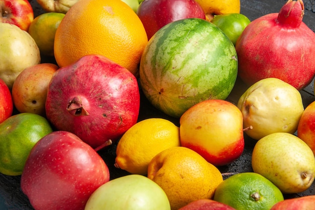 Front view fresh fruits composition apples pears and tangerines on dark-blue desk fruit ripe tree color fresh mellow many