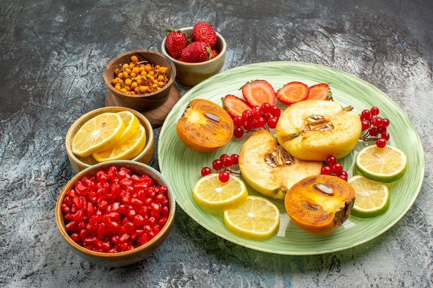 Front view fresh fruits quinces lemons and other fruits on light table fruit color fresh