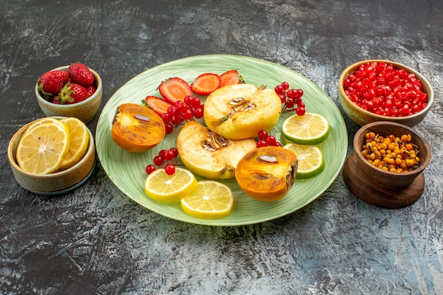 Front view fresh fruits quinces lemons and other fruits on a light table fruit fresh many