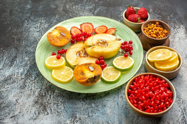 Front view fresh fruits quinces lemons and other fruits on light table