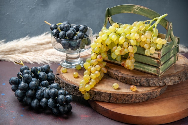 Front view fresh grapes green and black fruits on dark surface wine grape fruit ripe fresh tree plant