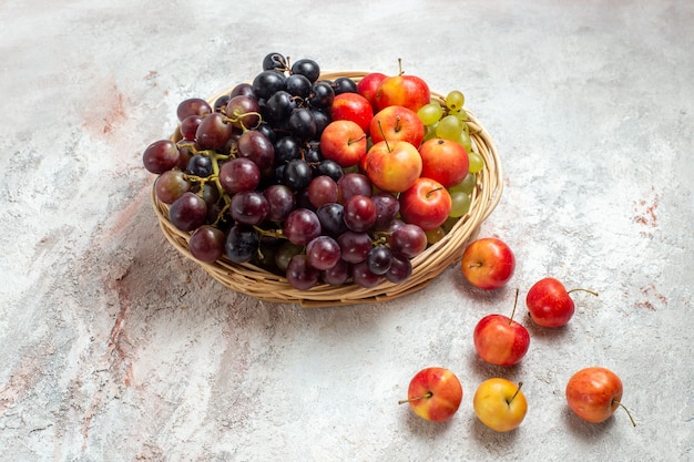 Front view fresh grapes with plums on white space