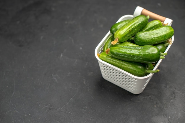 Free photo front view fresh green cucumbers inside basket on dark background photo salad meal food health color