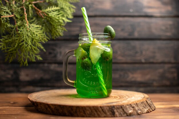 Front view of fresh juice with apple and feijoa on a wooden tray