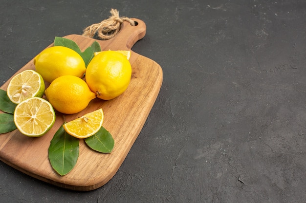 Front view fresh lemons sour fruits on dark background