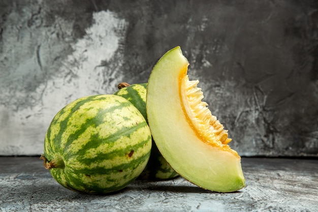 Front view fresh melon with watermelon on dark-light background