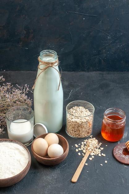 Front view fresh milk with raw cereals on a gray background color pie raw breakfast milk dairy cake