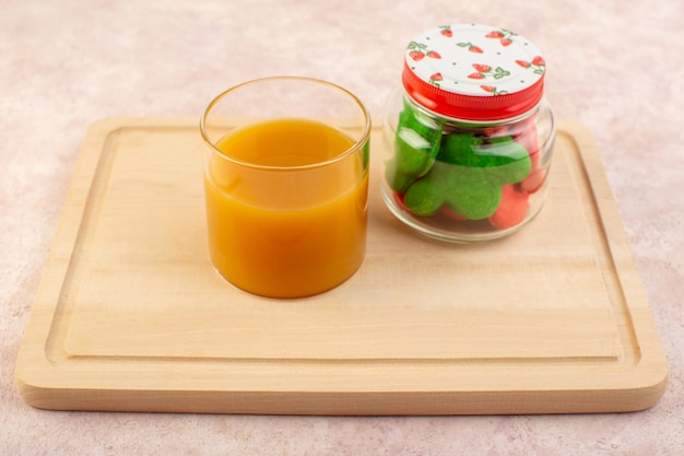 Front view of fresh peach juice sweet and delicious with colorful cookies inside can