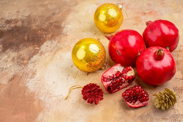 Free Photo front view fresh pomegranates with christmas tree toys on light background color photo fruits juice mellow