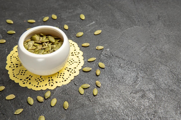 Front view fresh pumpkin seeds on a dark background seed color many pumpkin granule