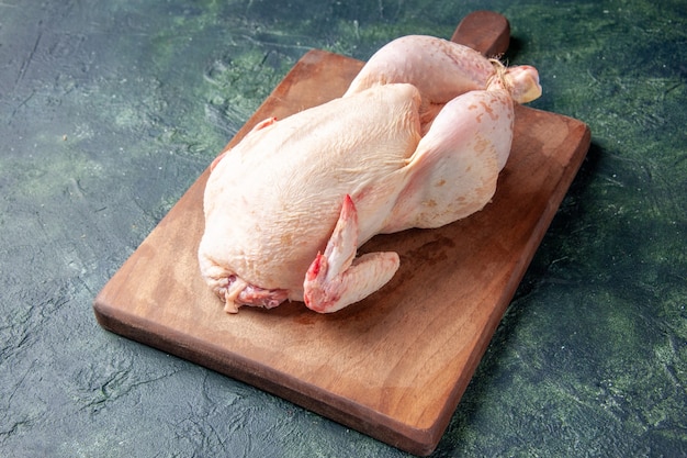 Front view fresh raw chicken on dark blue kitchen restaurant meal animal photo food chicken meat color farm