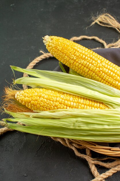 Front view fresh raw corns inside basket