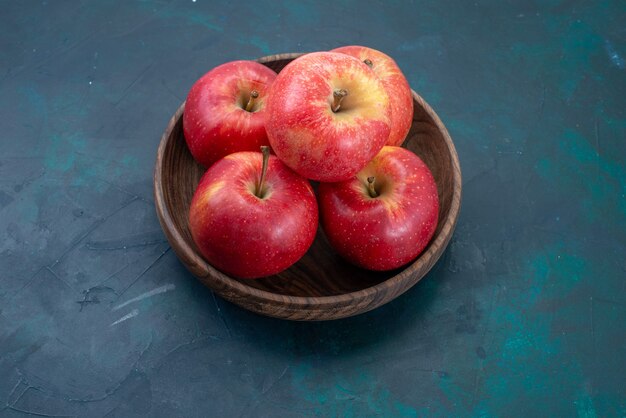 Front view fresh red apples mellow and fresh fruits on dark-blue desk fruits fresh mellow ripe tree