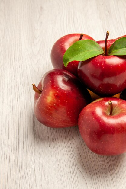 Front view fresh red apples mellow and ripe fruits on white desk fruits color fresh plant red tree