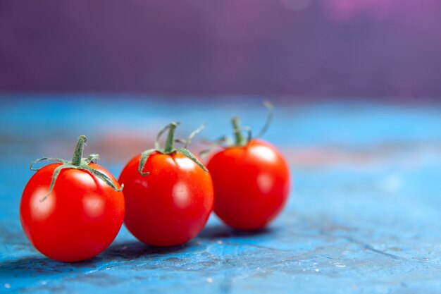 Front view fresh red tomatoes on the blue table