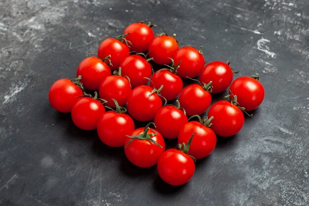 Front view fresh red tomatoes lined on dark table