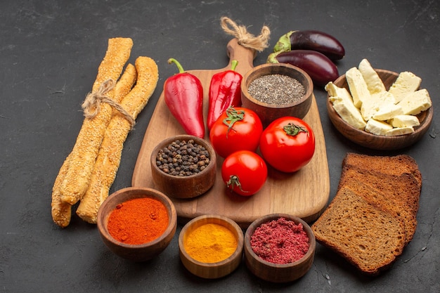 Free Photo front view fresh red tomatoes with bread and different seasonings on dark space