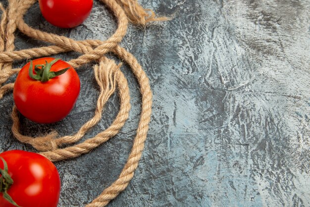 Front view fresh red tomatoes with ropes