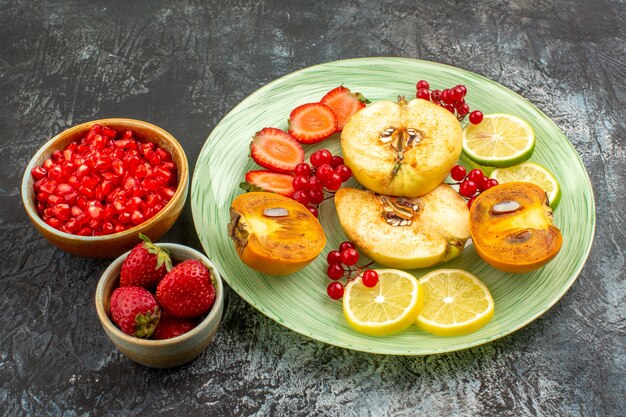 Free Photo front view fresh sliced fruits inside plate on light-dark table fruit many fresh