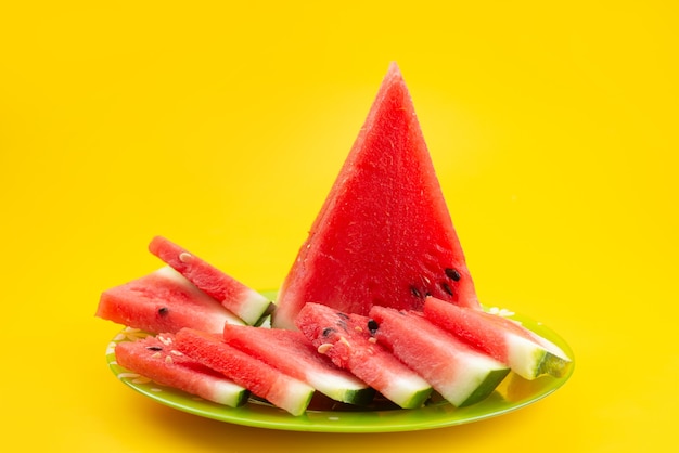 A front view fresh sliced watermelon sweet and mellow on yellow, fruit juice color