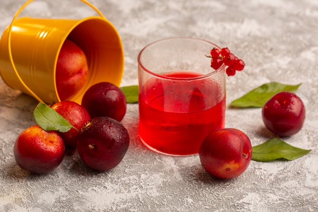 Free Photo front view fresh sour plums with red plum juice desk