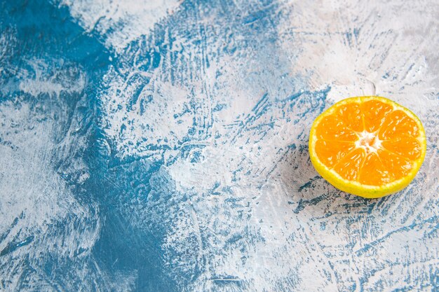 Front view fresh tangerine slice on light-blue table