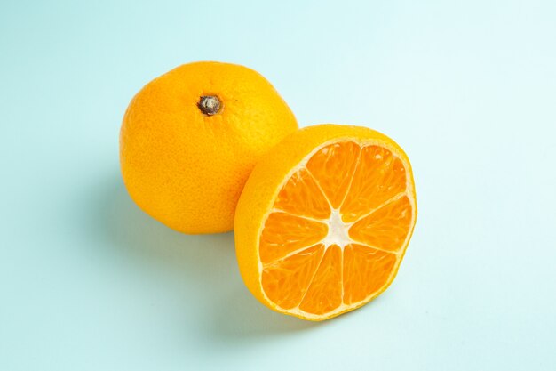 Front view fresh tangerine slices on a light-blue table