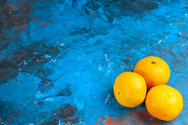 Front view fresh tangerines on blue desk