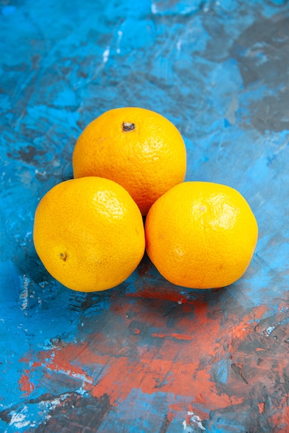 Front view fresh tangerines on a blue table color citrus fruit