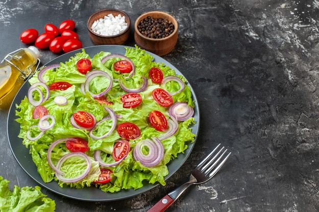 Front view fresh vegetable salad with green salad onions and tomatoes on the gray background meal salad food health photo diet ripe color