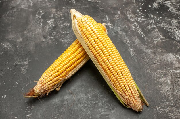 Front view fresh yellow corns on a dark background