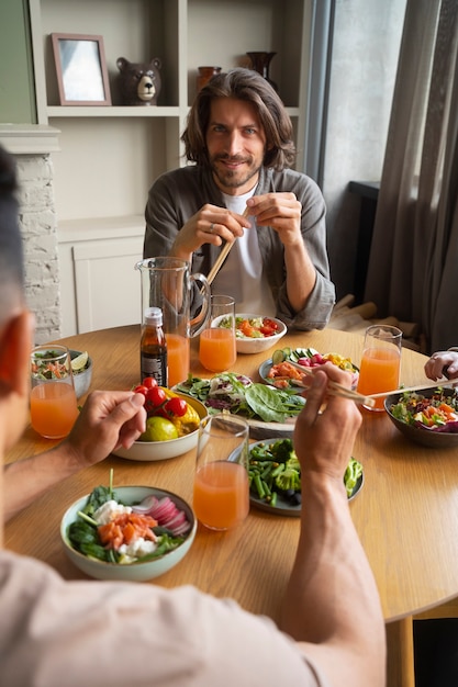 Free Photo front view friends eating salmon bowls