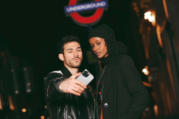 Front view friends taking selfie at night