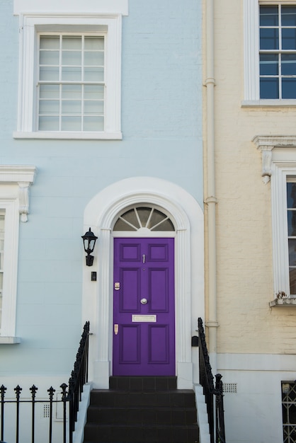 Free photo front view of front door with blue and beige wall