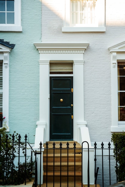 Front view of front door with blue and white wall and plants