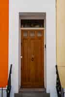 Free photo front view of front door with orange wall