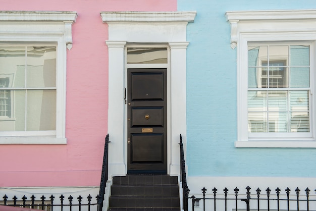 Front view of front door with pink and blue wall