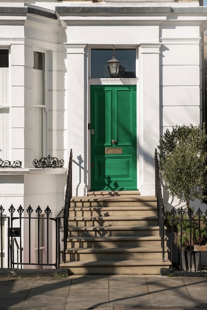 Free Photo front view of front door with white wall and plants