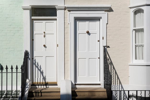 Free Photo front view of front doors with green and beige wall