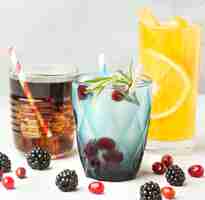 Free photo front view of fruit cocktail glasses with straws