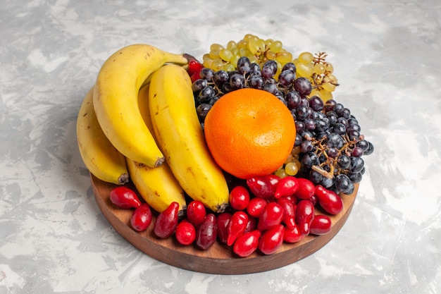 Front view fruit composition bananas dogwoods and grapes on white surface fruit berry freshness composition vitamine color