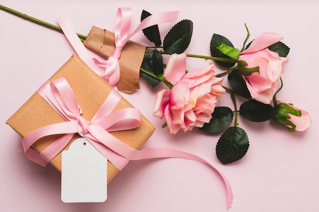 Front view of gift box with rose bouquet and ribbon