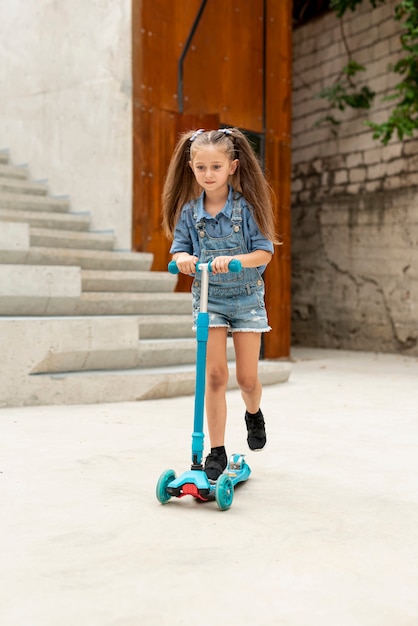 Front view of girl on blue scooter