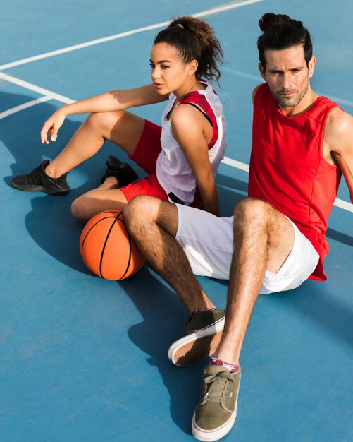 Front view of girl and boy with basket ball